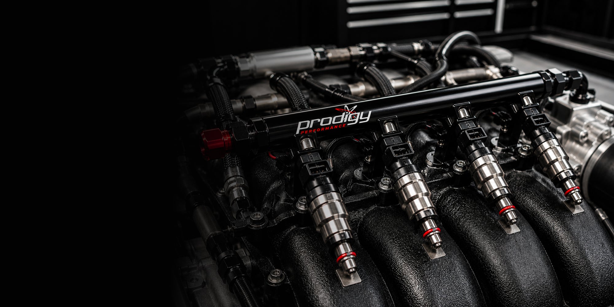 Close-up of a car engine with 'Prodigy' branding on a dark background