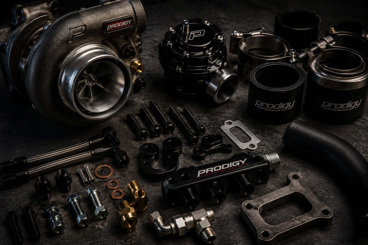 Collection of Prodigy brand automotive parts on a dark surface