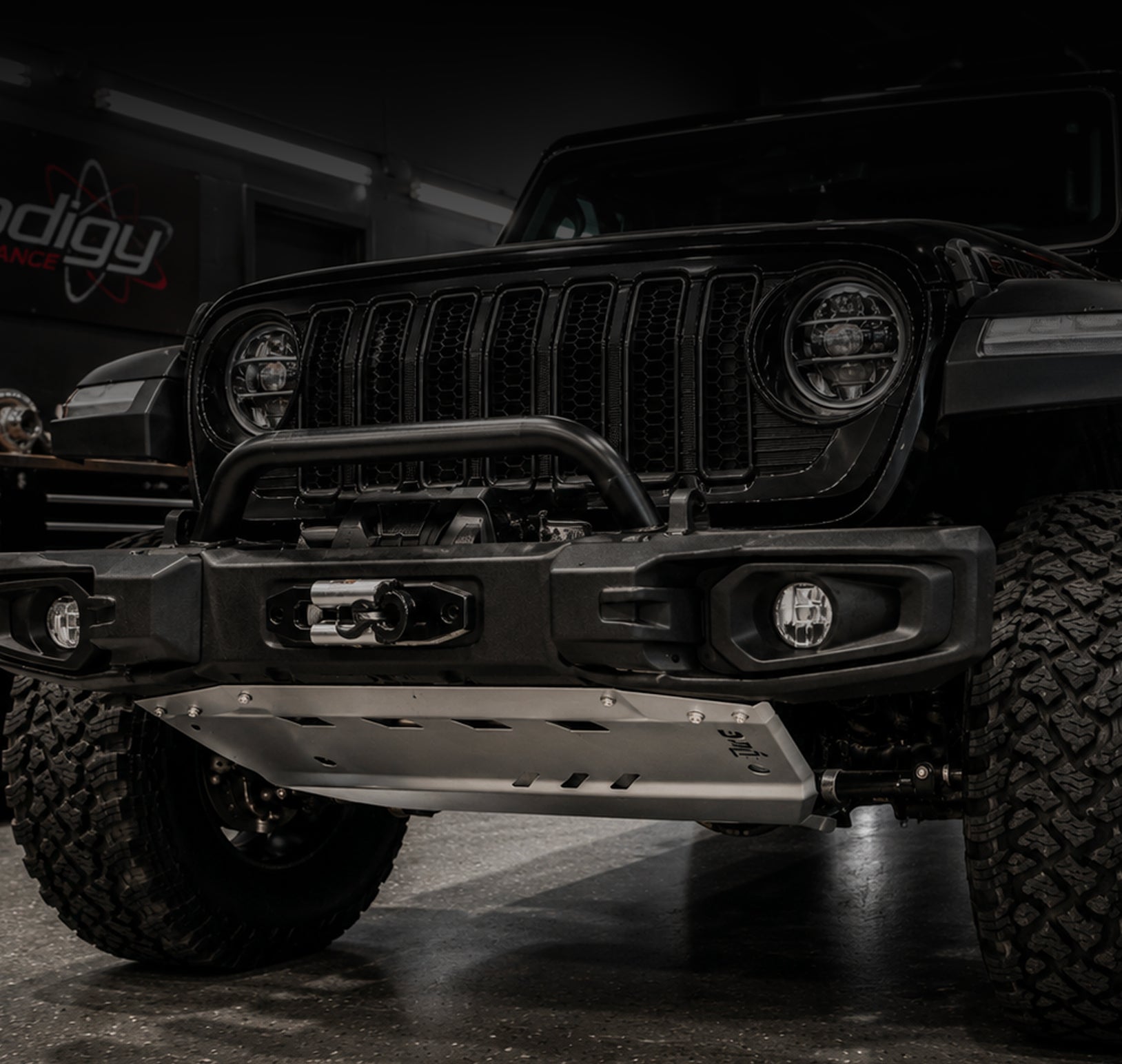 Black Jeep Wrangler with 'Mopar' branding in a dark setting
