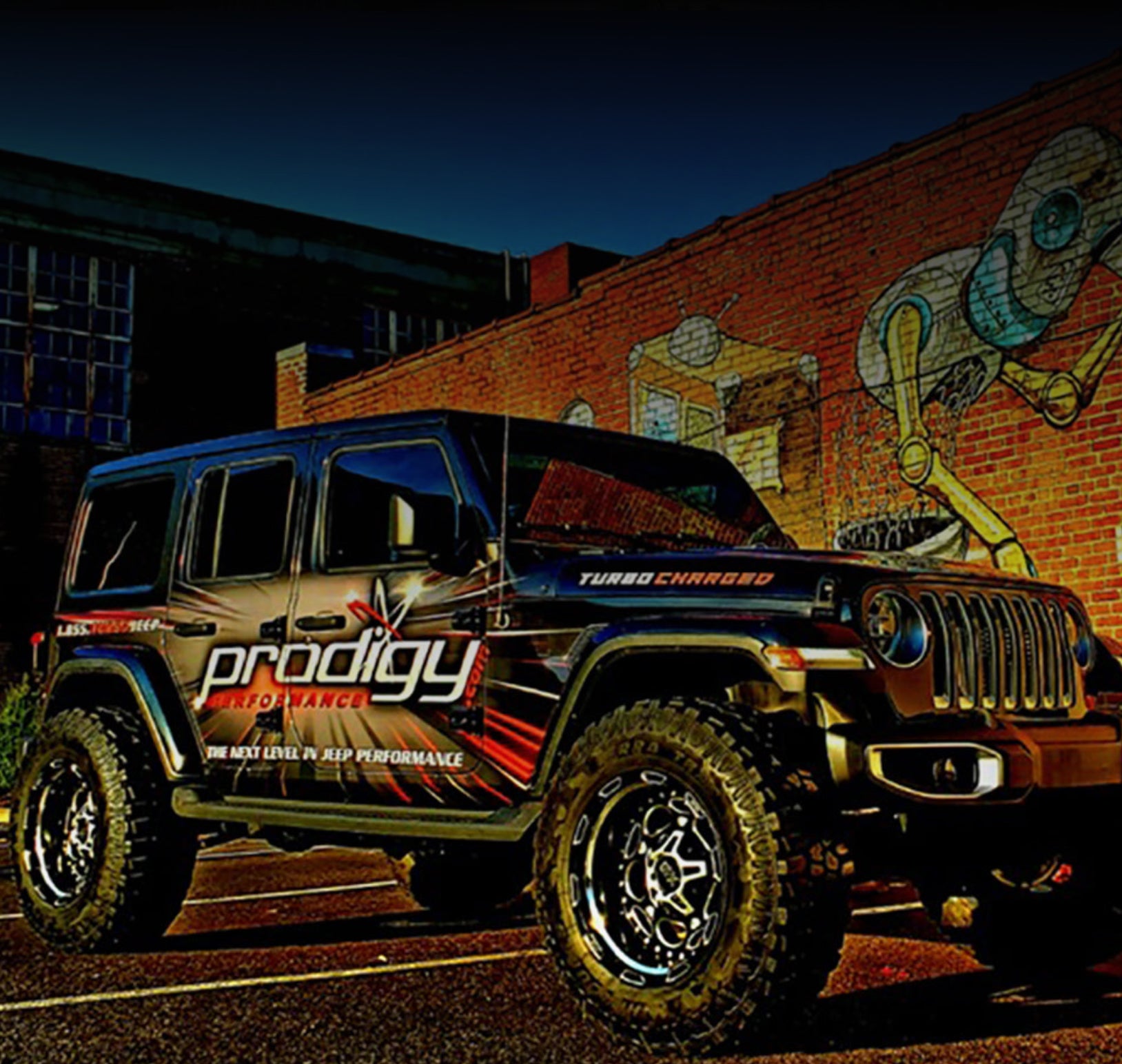 Jeep Wrangler with 'Prodigy Performance' branding parked in front of a graffiti-covered wall.